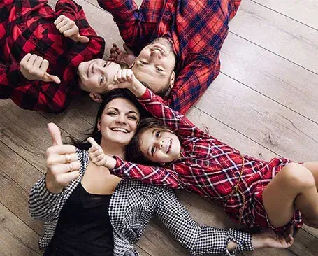 Hardwood-installation-After Happy family laying on hardwood floor | CR Carpet
